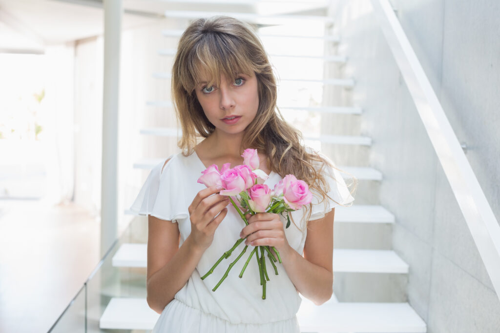 portrait-beautiful-sad-woman-with-flowers-stairs